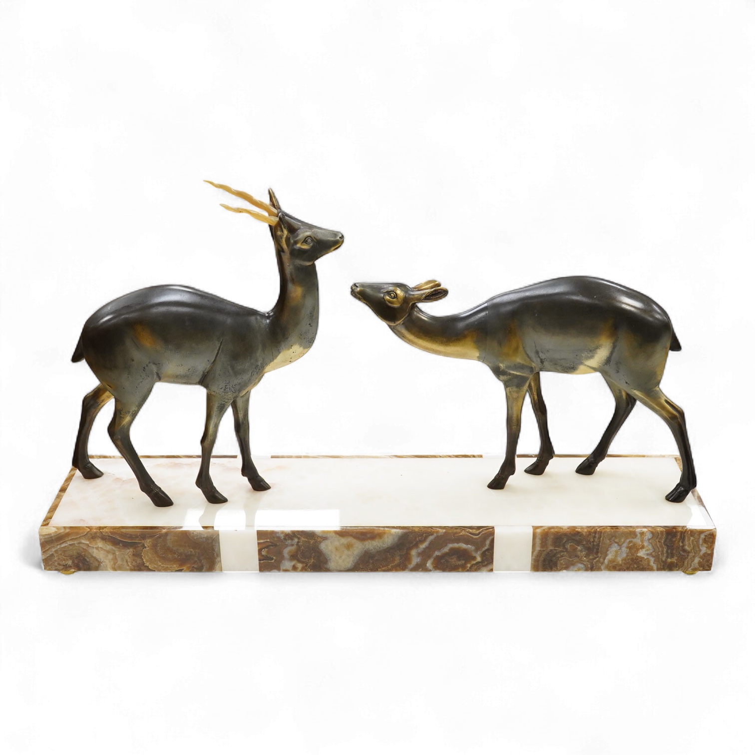 An Art Deco spelter and marble stag and deer group, 70cm wide